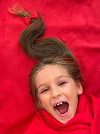 Girl surprised with hairdo new year christmas tree happy and mouth open 
