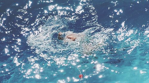 Man swimming in pool