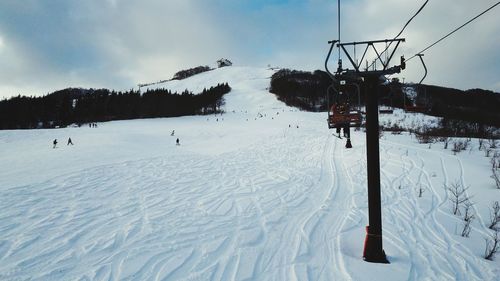 Ski lift on snow covered landscape