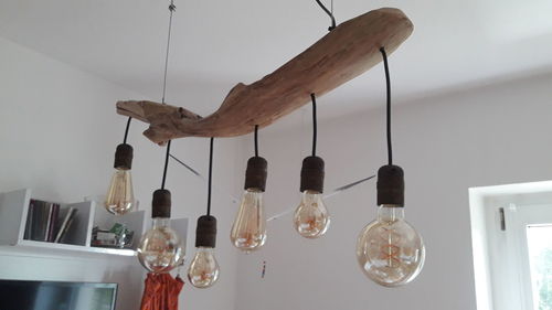 Light bulbs hanging on wall at home