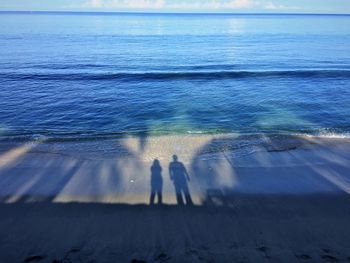 People on beach against sky