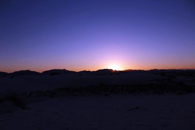 Scenic view of silhouette landscape against clear sky at sunset