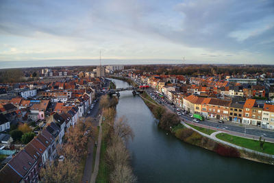 High angle view of river amidst buildings in city against sky