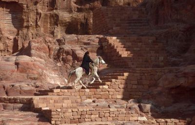 Man riding on horse at petra steps