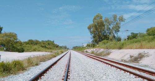 View of railroad tracks on field against sky