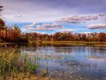 Scenic view of lake against cloudy sky