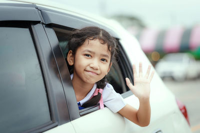 Portrait of happy girl in car