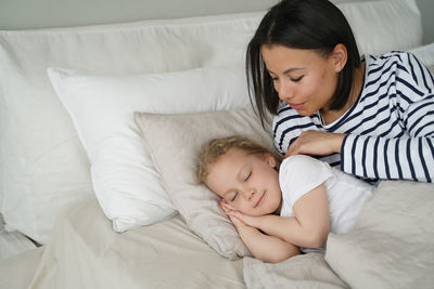 Young woman sleeping on bed at home