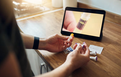 Midsection of woman using mobile phone