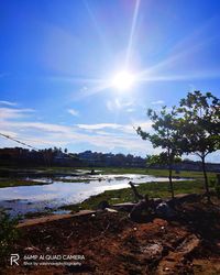 Scenic view of lake against sky on sunny day