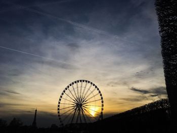 Low angle view of ferris wheel against sky
