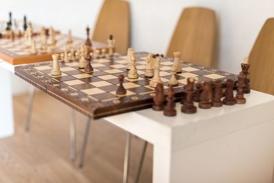 Close-up of chess board with pieces on table