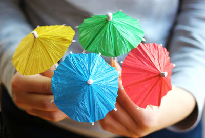 Close-up of hand holding multi colored toy