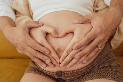 Midsection of woman holding hands