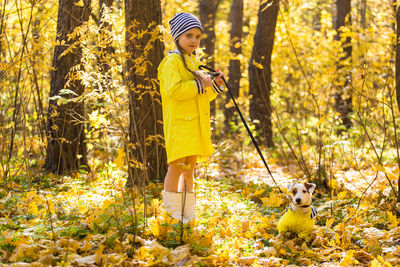 Full length of a boy standing in a forest