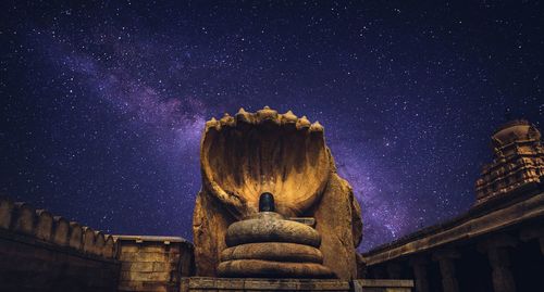 Low angle view of illuminated building against sky at night