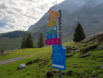 Information sign on landscape against sky