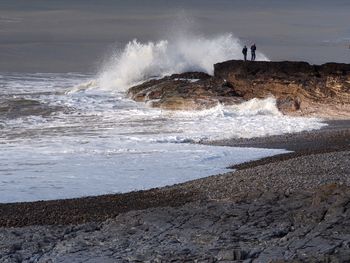 Waves splashing on rocks at beach