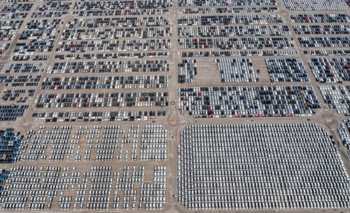 Aerial view of new cars lined up at industrial port to export