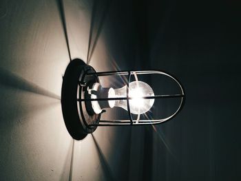 Close-up of illuminated light bulb mounted on wall