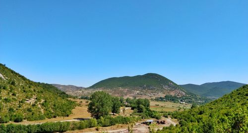 Scenic view of mountains against clear blue sky