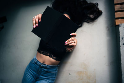 High angle view of woman sitting on floor