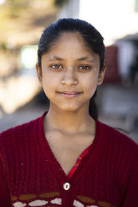 Portrait of young woman standing outdoors