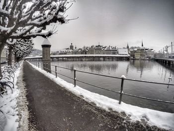 Snow covered city against sky