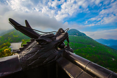 Statue on mountain against sky