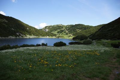 Scenic view of lake and mountains against sky