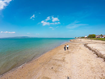 Scenic view of sea against blue sky