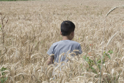 Rear view of man standing on field