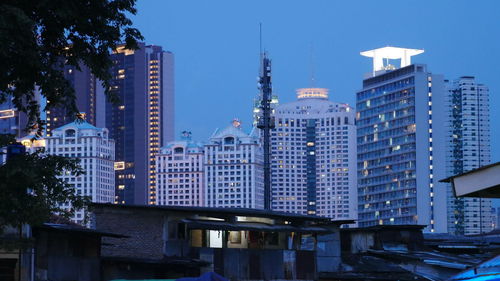 Modern buildings in city against sky