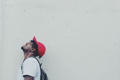 Low angle view of woman standing against wall