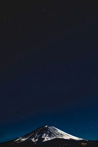 Low angle view of mountain against sky at night