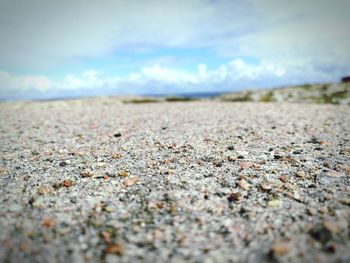 Surface level of sand on beach against sky