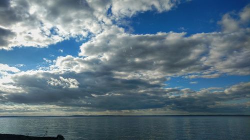 Scenic view of sea against storm clouds