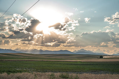 Scenic view of field against sky during sunset