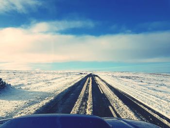 Road against sky seen through car windshield