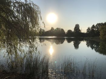 Scenic view of lake against sky during sunset