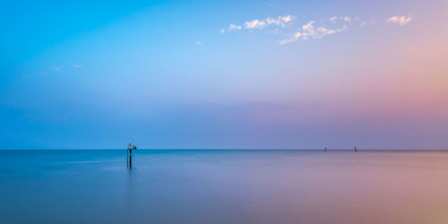 Scenic view of sea against sky at sunset