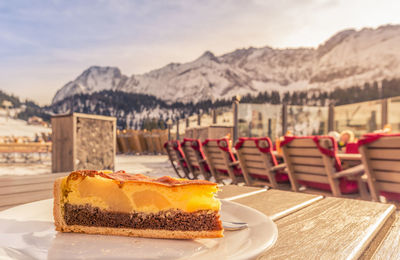 Close-up of cake on table against mountain