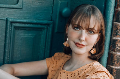 Close-up of woman sitting by door 