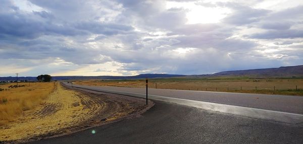 Empty road along countryside landscape