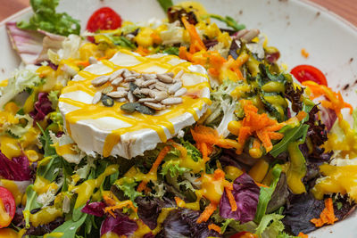 Typical spanish goat cheese salad with seasonal vegetables and seeds