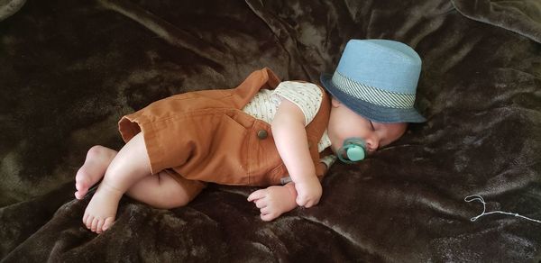 High angle view of baby boy sleeping on bed