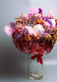 Close-up of pink flower vase against glass wall