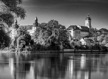 Reflection of buildings and trees in lake