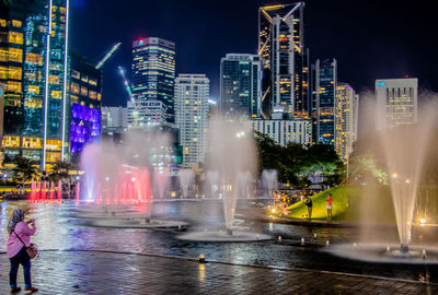 Illuminated buildings in city at night