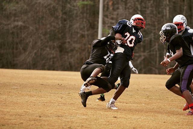 leisure activity, lifestyles, men, togetherness, focus on foreground, sport, boys, casual clothing, field, person, grass, full length, fun, bonding, enjoyment, playing, outdoors